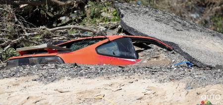 A Pontiac Fiero buried under debris in Sanford, MI